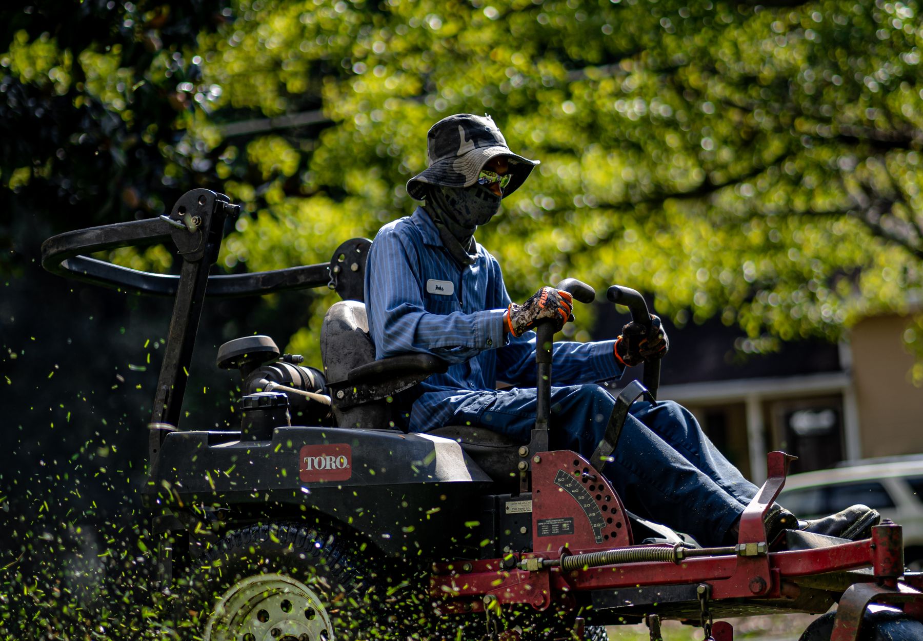 A commercial mower cutting a green lawn